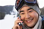 Man Using Cellular Phone on Ski Hill, Whistler, British Columbia, Canada