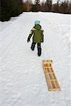 Boy Pulling Toboggan, Whistler, British Columbia, Canada