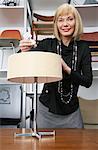 Portrait of Woman Putting Lightbulb in Furniture Store