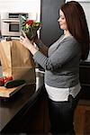 Woman Removing Groceries from Bag
