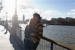 Couple by the Thames River, London, England