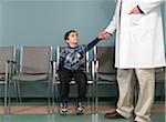 Doctor Holding Boy's Hand