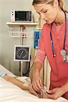 Nurse Checking Patient's Oxygen Monitor