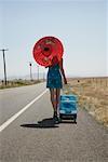 Woman Walking on Side of Road