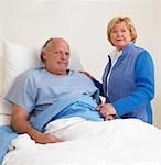 Woman with Sick Man in Hospital Room