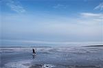 Boy Skating on Frozen Lake