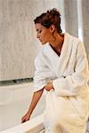 Woman Sitting on Edge of Tub