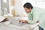 Man Doing Home Renovations, Using Computer