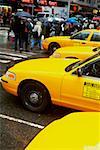 Yellow taxi waiting at the zebra crossing
