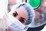 Portrait of a female surgeon in a surgical cap and surgical mask