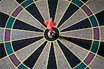 Close-up of a dart in the bulls- eye of a dart board