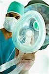 Portrait of a male surgeon holding an oxygen mask