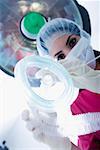 Low angle view of a female surgeon holding an oxygen mask