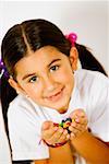 Portrait of a girl holding candies in her hands