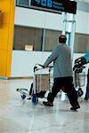 Side profile of a person pushing a luggage cart, Madrid, Spain