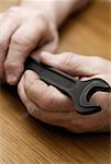 Close-up of a person's hand holding a spanner
