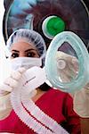 Low angle view of a female surgeon holding an oxygen mask