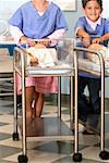 Boy and a girl pushing two trolleys with dolls in incubators