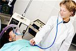 Boy imitating a doctor and examining a patient with a stethoscope