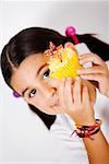 Portrait of a girl showing a cupcake