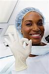 Close-up of a female surgeon smiling and making an OK sign