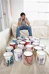 Interior Decorator Looking over Paint Cans