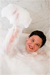 Portrait of a boy smiling in a bubble bath