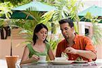 Teenage girl and a mid adult man sitting in a restaurant