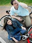 High angle view of a mid adult couple sitting with bicycles and smiling