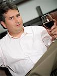 Portrait of a mature man holding a glass of red wine