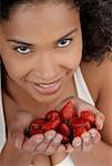 Portrait of a young woman with strawberries in her hands