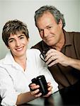 Portrait of a mature couple holding cups of tea and smiling