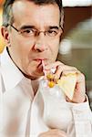 Portrait of a mid adult man drinking pina colada with a drinking straw