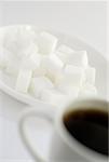 Close-up of a cup of black tea with sugar cubes