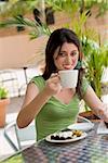 Portrait of a teenage girl drinking tea at a restaurant