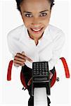 High angle view of a businesswoman holding an adding machine tape and smiling