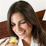 Close-up of a young woman holding a cupcake and smiling