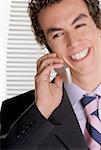 Gros plan d'un homme d'affaires, parler sur un téléphone mobile et souriant