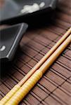 Close-up of two chopsticks on a mat
