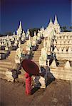 High angle view of a woman holding a parasol and standing in front of a pagoda, Mingun, Sagaing Divison, Myanmar