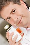 Portrait of a mature man holding a glass of whiskey