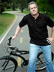 Mature man standing with a bicycle