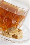 Close-up of a brown sugar with a cup of black tea