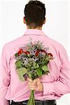 Man holding bunch of flowers