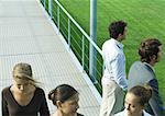 People standing and walking on walkway