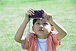 Boy using digital camera