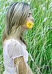 Woman with flower in mouth, eyes closed