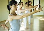 Yoga class standing in shiva posture