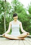 Woman sitting indian style on deck