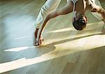 Yoga class, woman doing yoga pose (prasarita padottanasana)